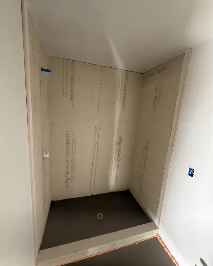 During: the shower base set and the walls boarded
